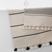 striped cotton bath rugs with pom poms, stone-grey
