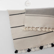 striped cotton bath rugs with pom poms, ivory-black