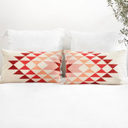 Set of Two Blush and Pink Lumbar Pillows on Bed