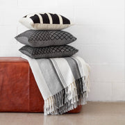 Handwoven Pillows and Throws in Black and Cream on Leather Bench