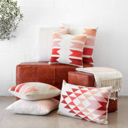 Blush, Pink, and Rust Accent Pillows on Leather Bench
