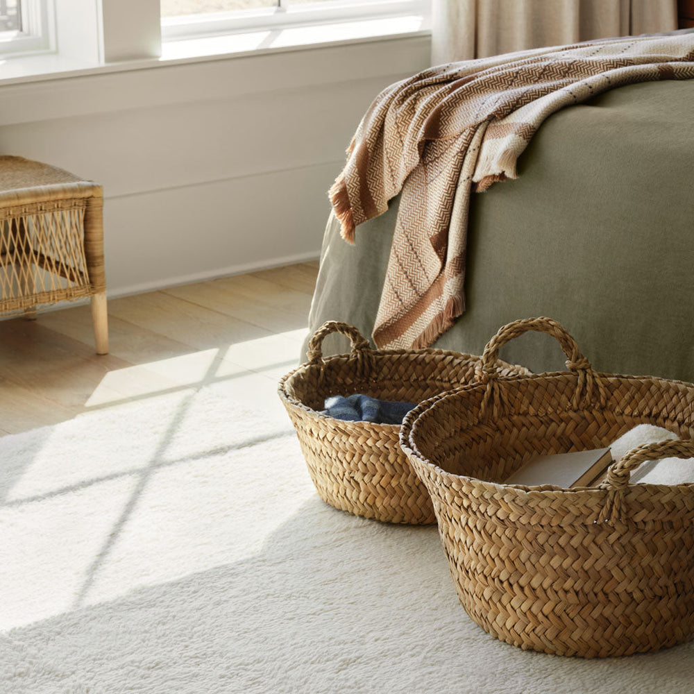 Alpaca throw on bed with woven baskets