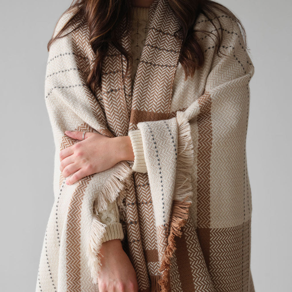 Model wrapped in herringbone throw