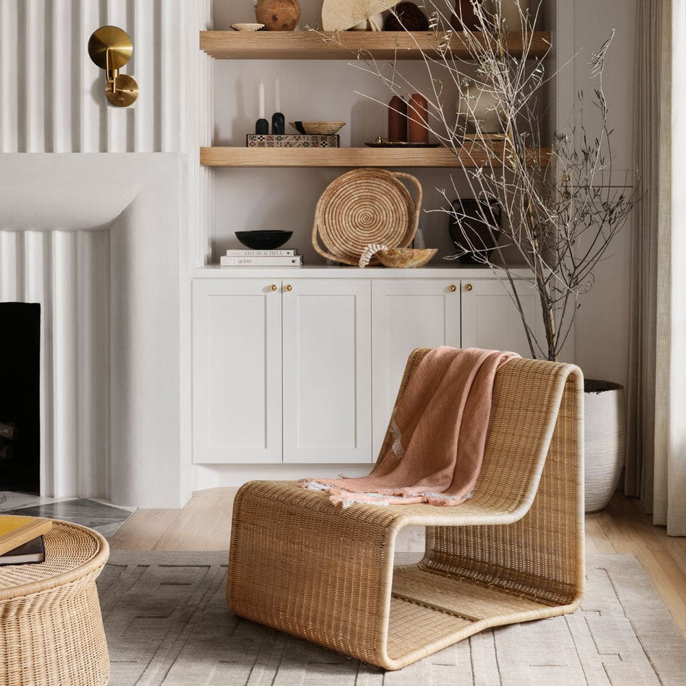 amrya area rug styled with wicker chair in living room, light grey