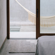 Handwoven Wool Accent Rug in Grey and Cream Placed by Door