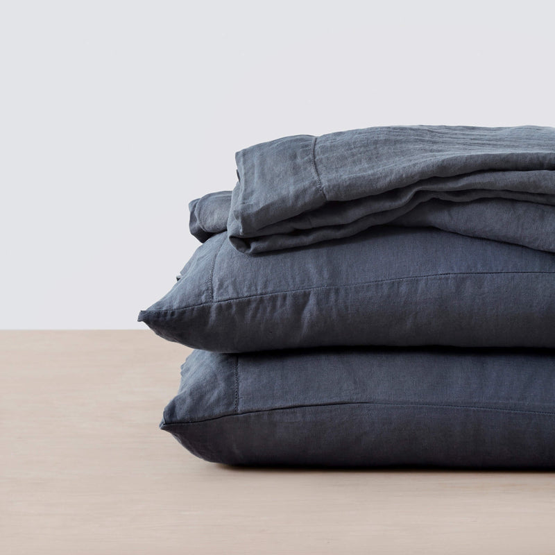 stack of indigo linen bedding, slate-blue