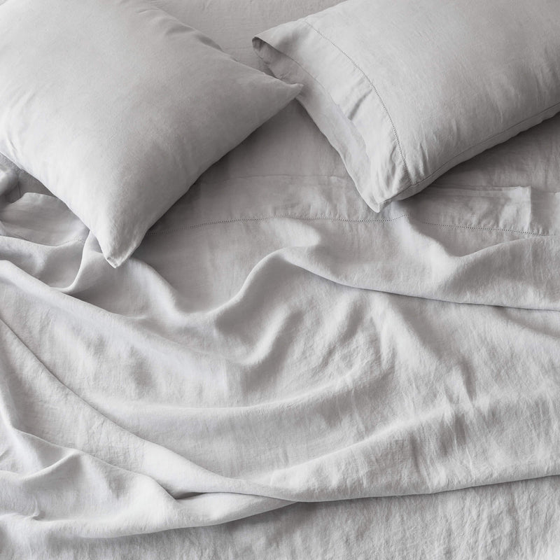 Overhead of Linen Sheet Set and Pillows from The Citizenry, light-grey