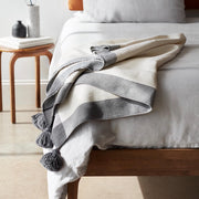 Cotton blanket handcrafted in Morocco draped over end of bed