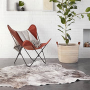 Woven throw on leather butterfly chair, cognac-leather