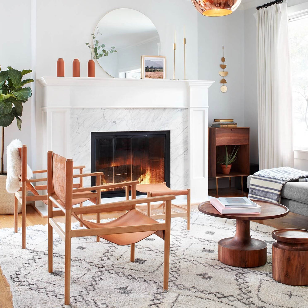 Large circular mirror above fireplace