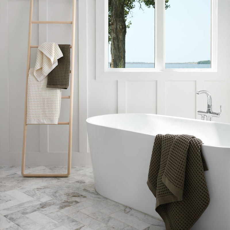 Green waffle towel in bathroom, olive