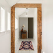 Woven runner in hallway with beams