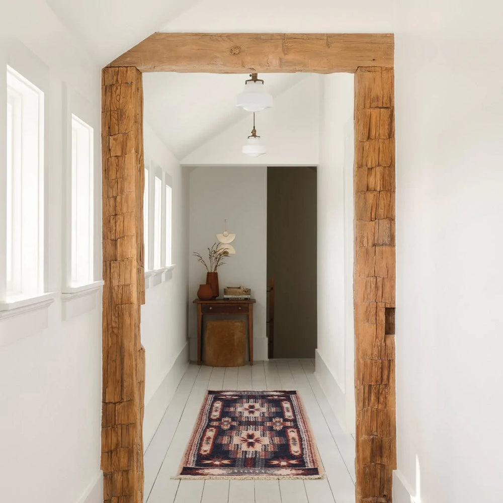Woven runner in hallway with beams