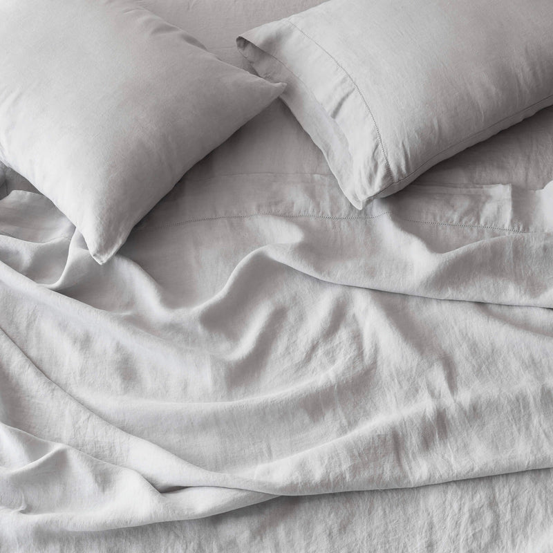 overhead of soft grey linen bedding, light-grey
