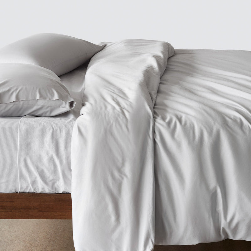 Side of organic turkish cotton duvet laying on bed, solid-light-grey