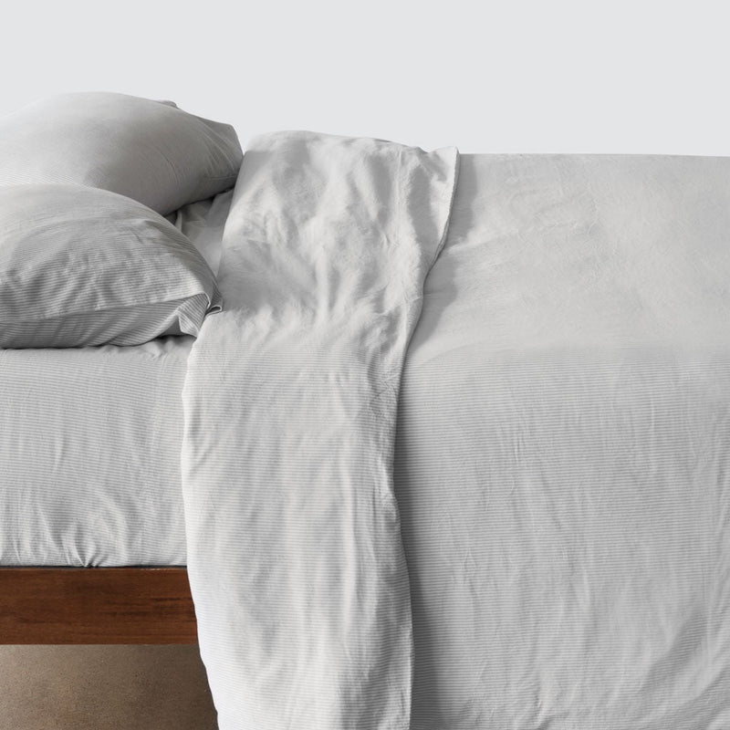 Side of bed with cotton duvet cover, light-grey-stripe
