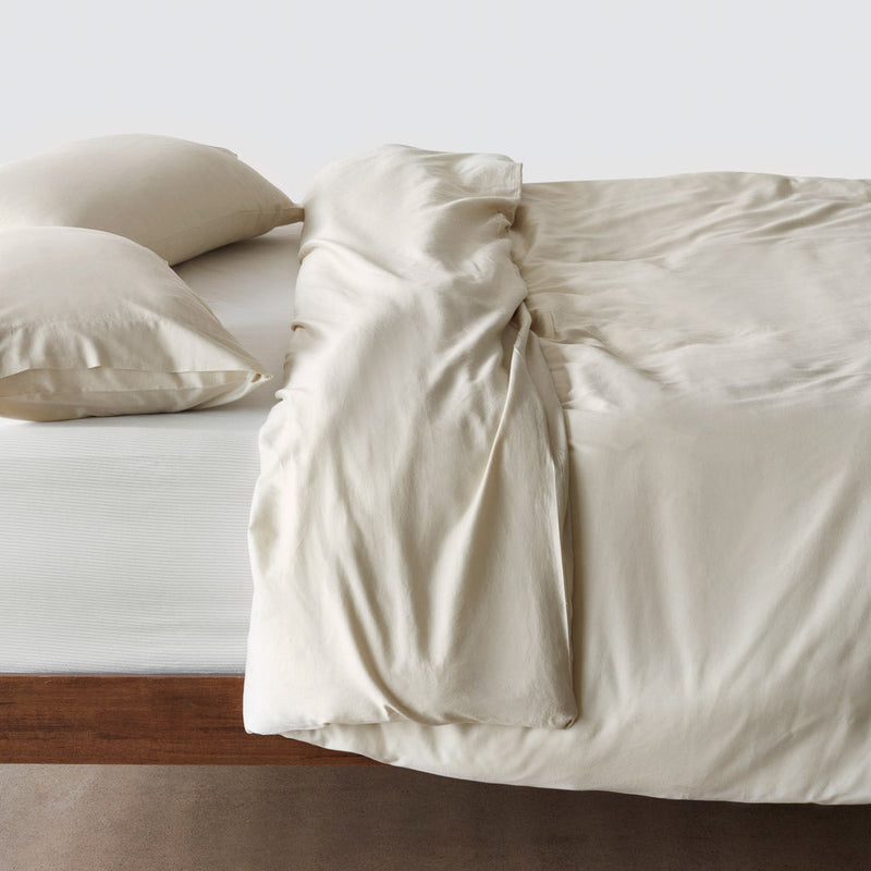 Side of bed with duvet cover,solid-sand