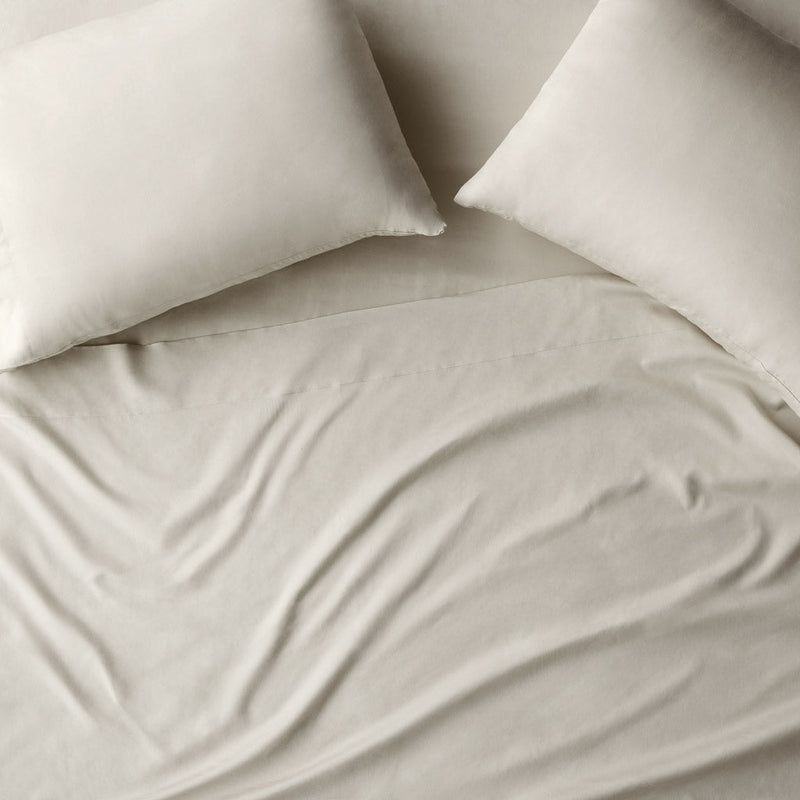 Overhead of pillows on duvet, solid-sand