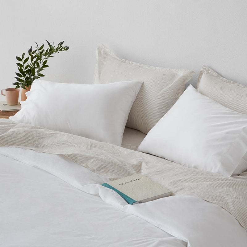 Book lying on top of duvet, white