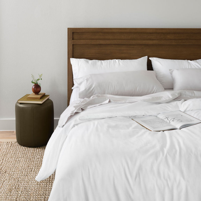 Open book on top of bed, white
