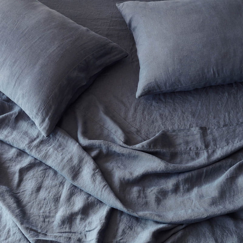 overhead of navy blue linen bedding, slate-blue