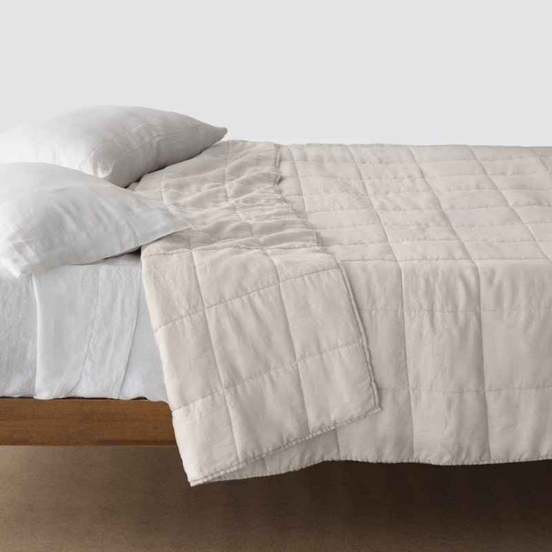 Side of bed with sand colored stonewashed linen quilt, solid-sand