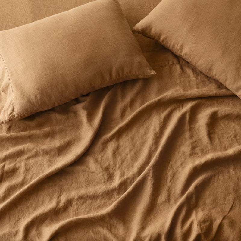 Overhead of camel sheet set and pillows,camel