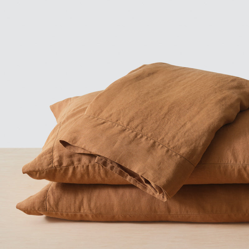 Top sheet folded on two camel pillows, camel