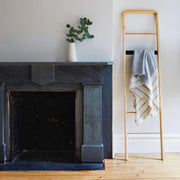 Alpaca throw hung over ladder next to fireplace