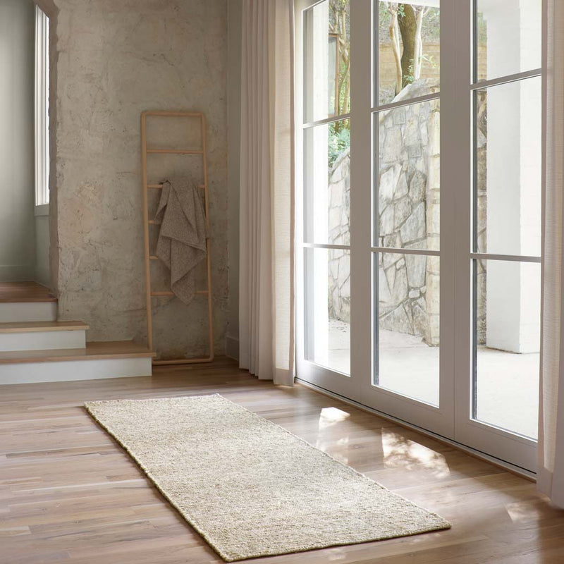 Natural jute runner styled in modern hallway, light