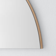 Close up of corner of half moon mirror