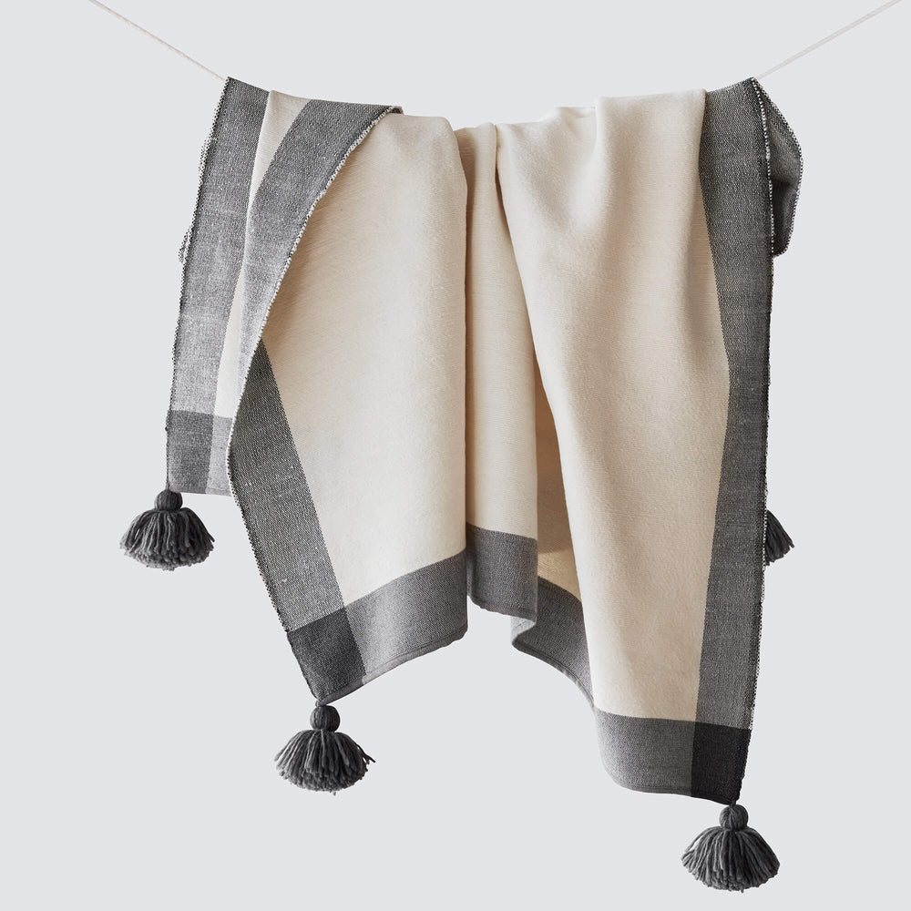 Handwoven cotton blanket with pom poms